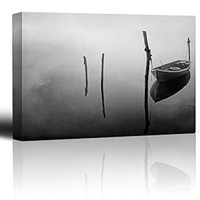 Black and White Photo of a Lone Boat Floating on a Lake - Canvas Art Home Art - 12x18 inches