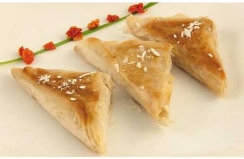 Simply Cuisine Kale Butternut Squash Cheese and Pine Nut Fillo Triangle - 100 per case.