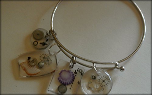 Time to Find charming seashells- Sliver color charm bracelet with four small watch crystal with watch parts and shell charms.