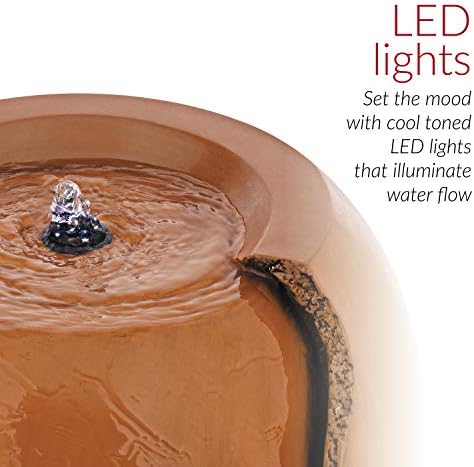 Tiered outdoor fountain with cascading water flowing from a jar on each tier.