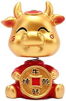 cow with toy car on head