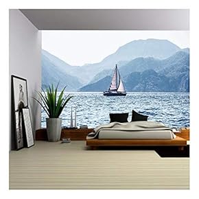 Beautiful Sea Landscape, Sailboat Sailing on The Distance on Great Majestic Mountains Background - Removable Wall Mural | Self-Adhesive Large Wallpaper - 66x96 inches