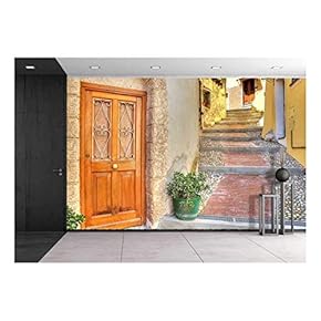 Wooden Door at The Entrance to Small House on Narrow Cobbled Street in Town of Ventimiglia in Liguria, Italy. - Removable Wall Mural | Self-Adhesive Large Wallpaper - 66x96 inches