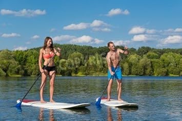 Alu-Dibond-Bild 120 x 80 cm: 'Young attractive couple on stand up paddle board in the lake, SUP', Bild auf Alu-Dibond