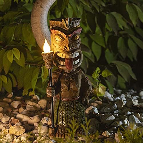 Solar-powered tiki torch in a garden setting.