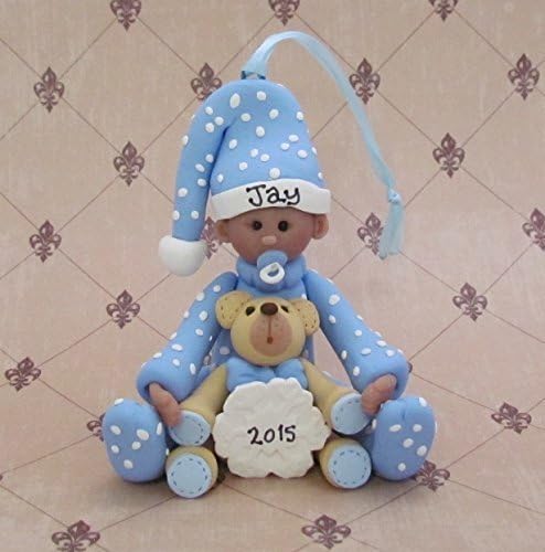 Baby boy with teddy bear and snowflake ornament
