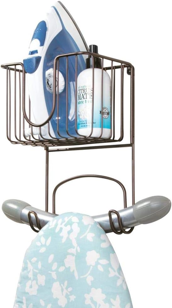 mDesign Wall Mount Metal Ironing Board Holder with Small Storage Basket - Holds Iron, Board, Spray Bottles, Starch, Fabric Refresher for Laundry Rooms - Bronze: Home & Kitchen