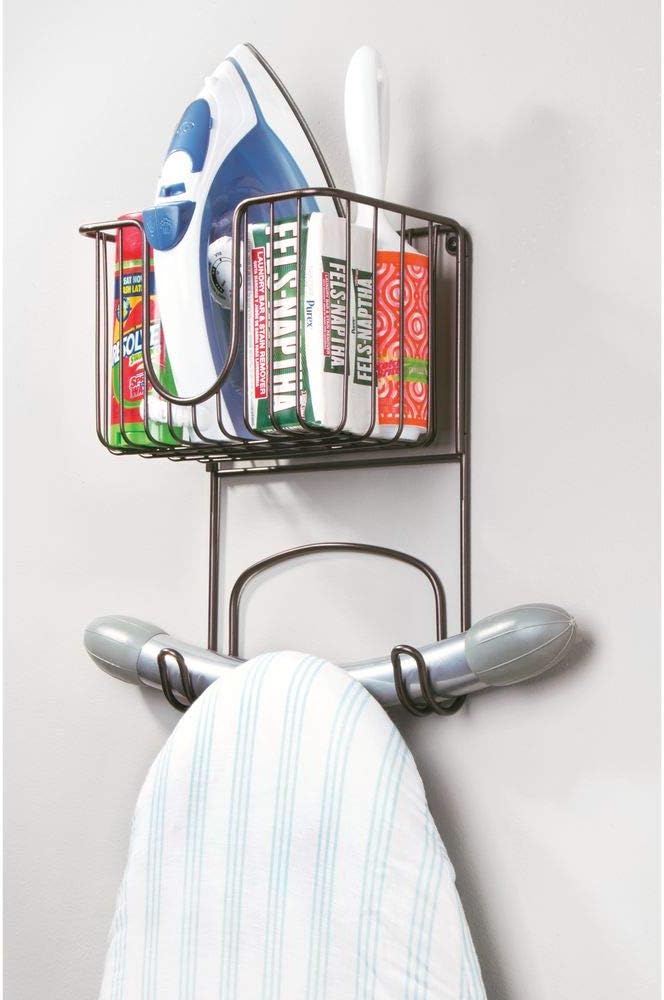 mDesign Wall Mount Metal Ironing Board Holder with Small Storage Basket - Holds Iron, Board, Spray Bottles, Starch, Fabric Refresher for Laundry Rooms - Bronze: Home & Kitchen