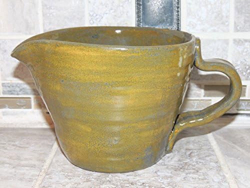 Ceramic Pitcher/creamer. Hand thrown ceramic. Food and dishwasher safe. Blue over green glaze, measures 6 x 4.6
