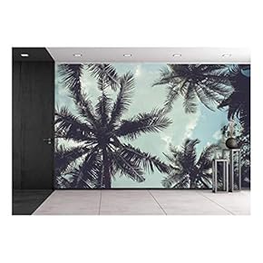 Branches of Coconut Palms Under Blue Sky - Removable Wall Mural | Self-Adhesive Large Wallpaper - 66x96 inches