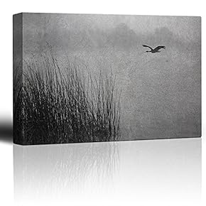 Black and White Photo of a Lone Seagull Flying Over a Pond - Canvas Art Home Art - 12x18 inches