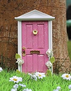 Pink magical fairy door with climbing flowers and fairy dust / key