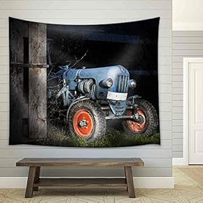 Blue Oldtimer Farming Tractor Standing Next to a Wooden Hut at Night with Red Painted Tires - Fabric Wall Tapestry Home Decor - 51x60 inches