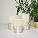 THE NIFTY NOOK Enchanting Flameless LED Candles Lights with Silver Banding and LEDs Wrapped Around Real Wax Pillar Candles with Remote Control - Ivory White, Set of 3