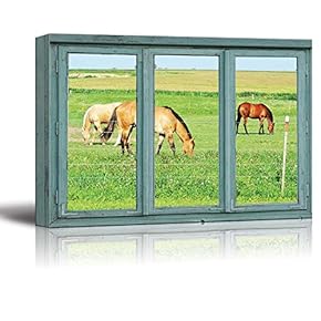 Horses in a Pasture grazing on Green Grass