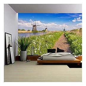 a Path Along Traditional Dutch Windmills on a Bright and Sunny Day at The Kinderdijk in The Netherlands. - Removable Wall Mural | Self-Adhesive Large Wallpaper - 66x96 inches