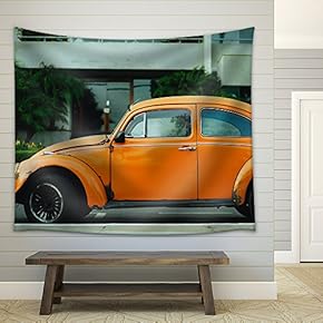 Antique Orange Car Parked in Front of a Building - Fabric Wall Tapestry Home Decor - 51x60 inches