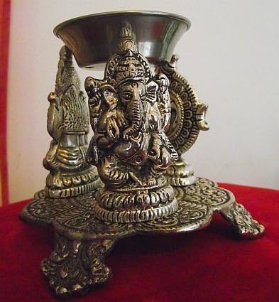 Oil Burner Ornately Engraved with Hindu Gods Ganesha,Laxmi and Om Symbol .Height approx 9cm, by 13cm at widest point