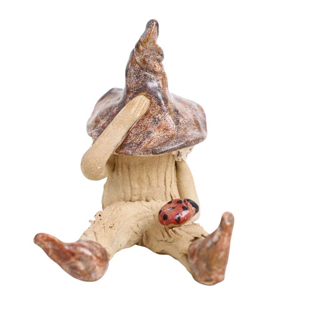 Fairy garden boy shy fairy figurine, pixie plant pot ornament, holding a ladybird, brown hat and boots.