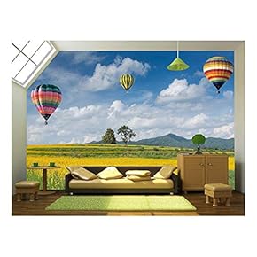 Hot Air Balloon Over Yellow Flower Fields Against Blue Sky - Removable Wall Mural | Self-Adhesive Large Wallpaper - 66x96 inches
