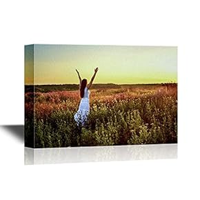 Young Woman in White Clothes Standing in Field on Sunset