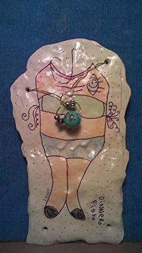 Pottery Monster Charm. A unique, one of a kind, hand sculptured gift. I have a fish body when you look at me one way, turn me sideways and I'm wearing a bikini! I'm a flat piece of pottery.