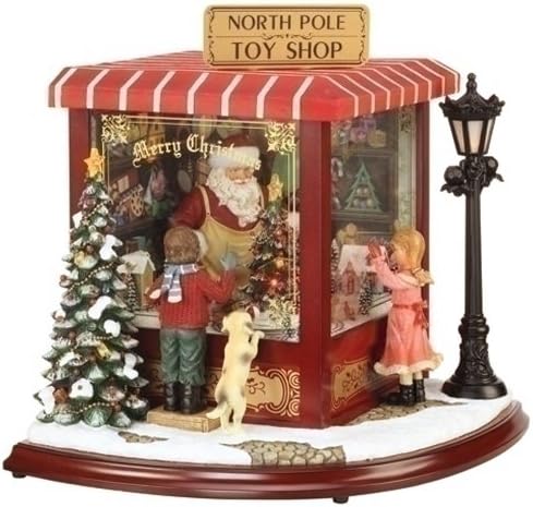 Amusements Exclusive Lighted Action Musical Featuring Santa in a Toy Shop with 2 Children Watching Him, 15.25 by 18-Inch
