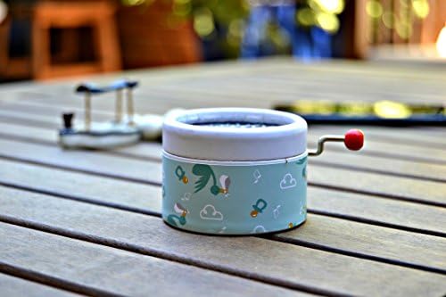 Esdemusica by RocĂo hand made music box for a baby. Exclusive design with clouds, storks, music notes and pacifiers. The song is the Brahms Lullaby in a hand crank music mechanism. 1,9 inch x 1,5 inch