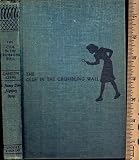 The Clue in the3 Crumbling Wall #22 Nancy Drew Mystery, blue book with blue silhouette endpapers.