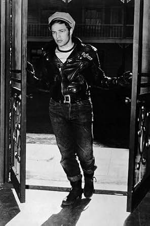 Marlon Brando in The Wild One leather jacket and cap in doorway at
