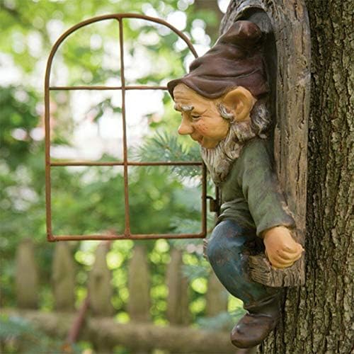 Colorful backyard gnome statue standing by a tree.