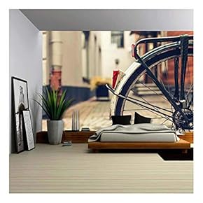 Wheel of a Bicycle in a Town - Removable Wall Mural | Self-Adhesive Large Wallpaper - 66x96 inches