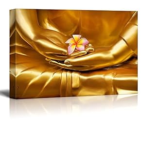 Gold Statue of Buddhas Hands Holding a Pink Plumeria Flower