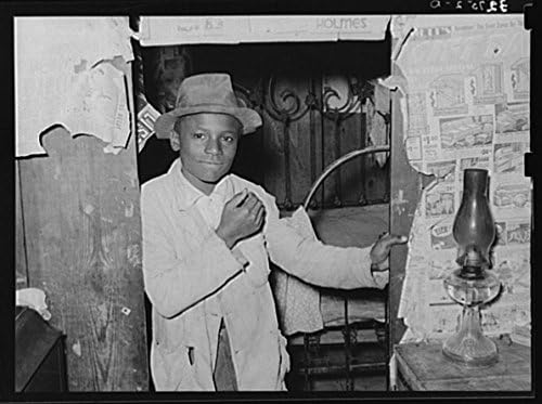 Young Negro strawberry picker in doorway. Near Hammond, Louisiana