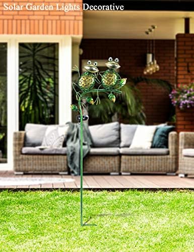 Solar outdoor lights illuminating a backyard in the evening hours.