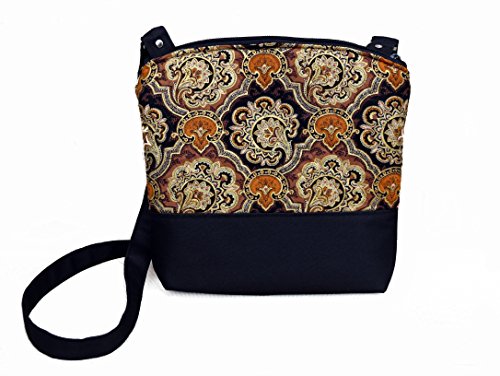 Lightweight arm / cross body purse. Fully padded and lined with black cotton fabric. With zipper and interior pockets. Washable and iron safe.