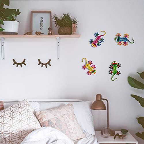 Colorful gecko metal wall decor artwork displayed on a garden fence during the day.