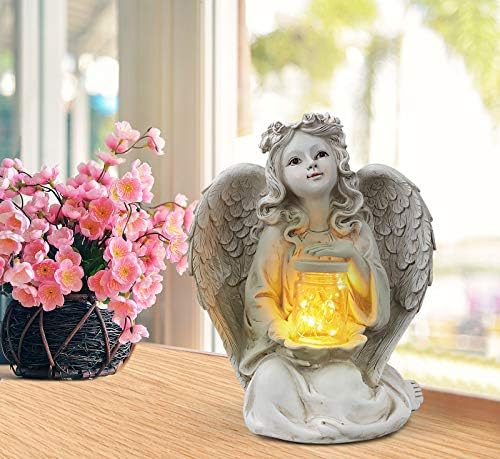 Solar guardian angel statue in a garden setting, worth $34.99 as of August 9, 2023.