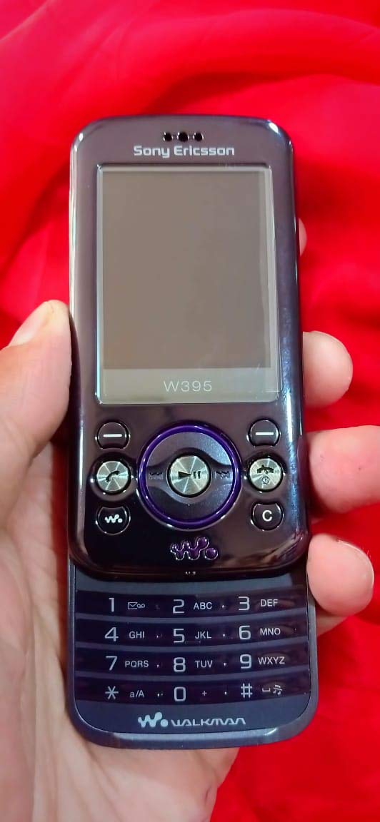 Sony Ericsson W395 Walkman Unlocked Mobile Phone Slider with OEM Accessories (Purple Black