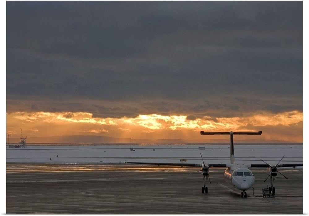 GREATBIGCANVAS Canada, British Columbia, Vancouver, Dash 8 Aircraft with Sun Lighting Distant Clouds Poster Pr.