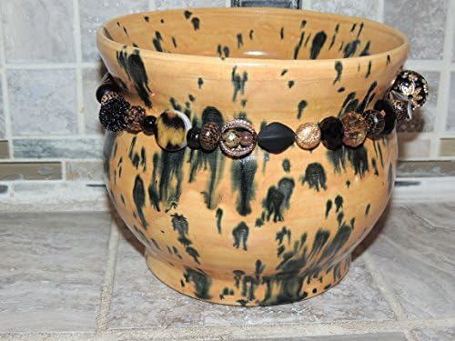 Beautiful Hand thrown one of a kind Bowl, Hand mixed tan animal print like speckled glaze, with beads around the base. Food and dishwasher safe. 7 wide, 5.6 tall ,Food,microwave and dishwasher safe.