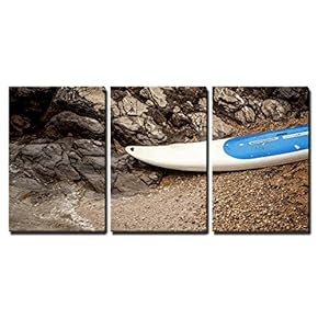 3 Piece Canvas Wall Art - Closeup Photo of Surfboard Lying on Sandy Beach at Sea Next to Jagged Cliffs - Modern Home Art Stretched and Framed Ready to Hang - 16"x24"x3 Panels