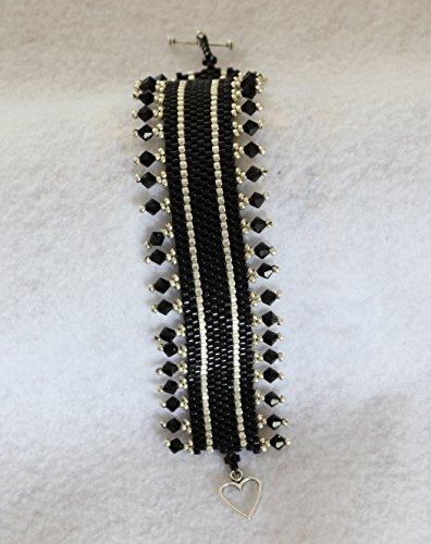 1166. Bead woven bracelet in silver and black glass beads with Swaroski crystal border and a toggle clasp.