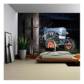 Blue Oldtimer Farming Tractor Standing Next to a Wooden Hut at Night with Red Painted Tires - Removable Wall Mural | Self-Adhesive Large Wallpaper - 66x96 inches
