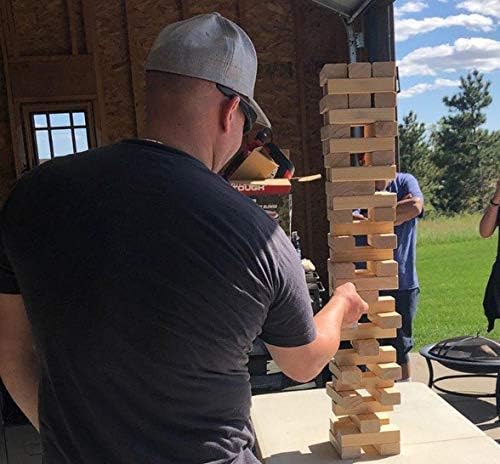 Wooden block tower game with player's hand carefully removing a block from the structure, surrounded by a protective case.
