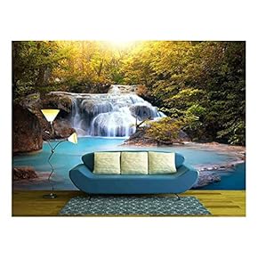 Sunlight Through Tree Leaves Lights Beautiful Waterfall in Forest