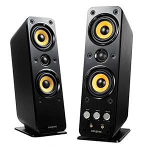 Black and gold speakers standing side by side