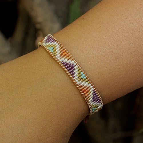 beaded friendship style bracelet with pink gemstone closure.