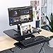 SLYPNOS Height Adjustable Standing Desk Converter Sit to Stand up Desk Riser, with Keyboard Mouse Deck and Cup Holder, 25 Inches Wide Ergonomic Workstation