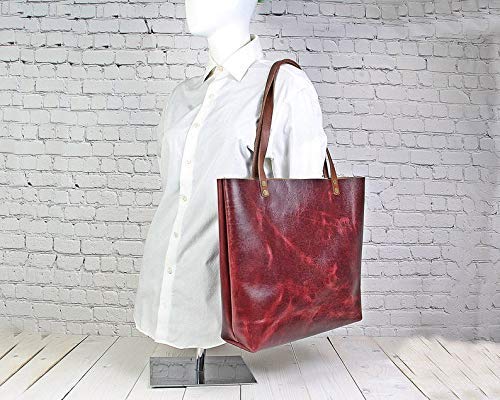 black leather tote bag with red inside